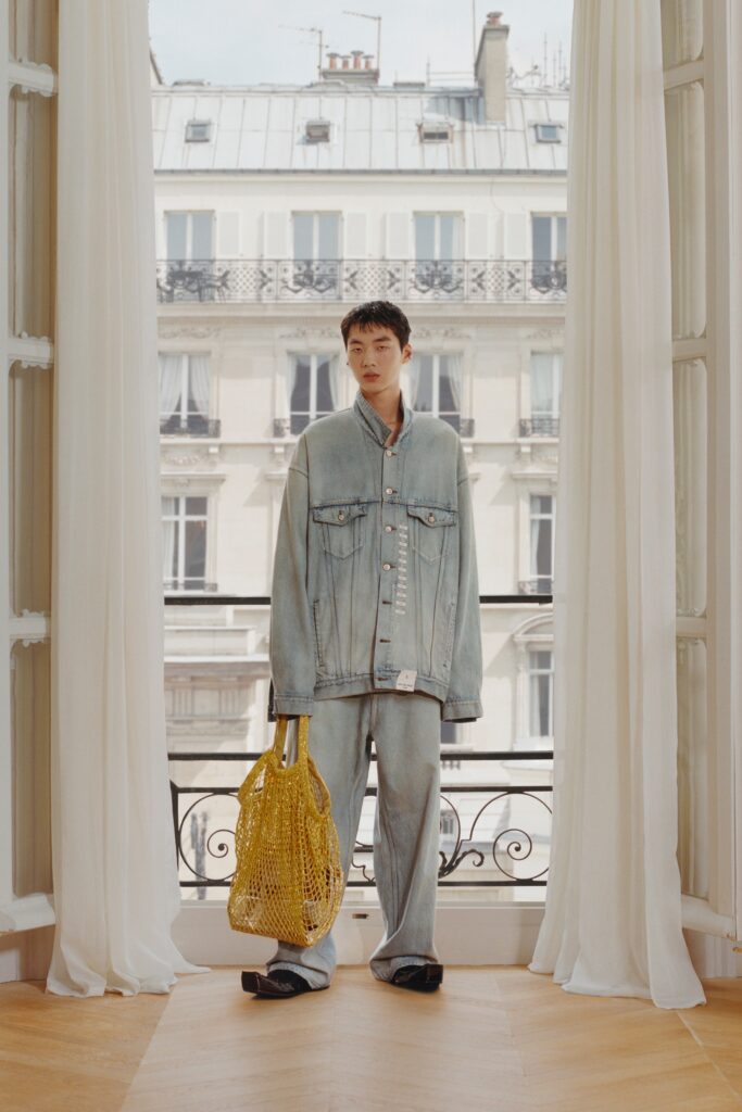 An oversized blue denim jacket with long sleeves and wide-leg pants for a relaxed look.