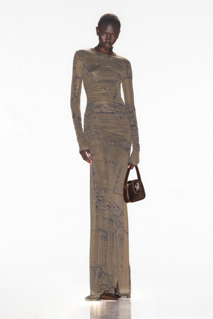 A fitted beige dress with long sleeves, a high neckline, and a printed design.