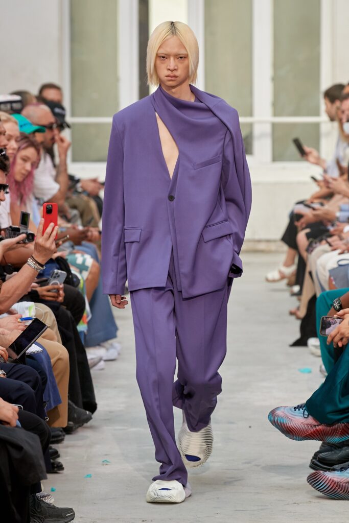 A relaxed purple suit featuring a long-sleeve design with an asymmetric detail.