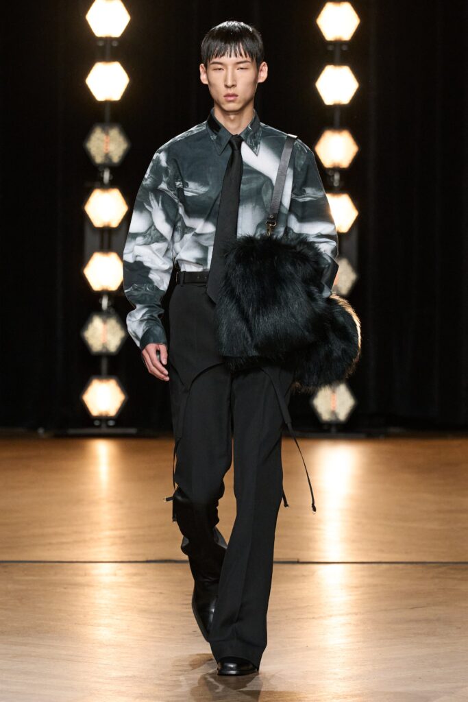 A fitted gray printed long-sleeve shirt paired with black straight-leg pants.