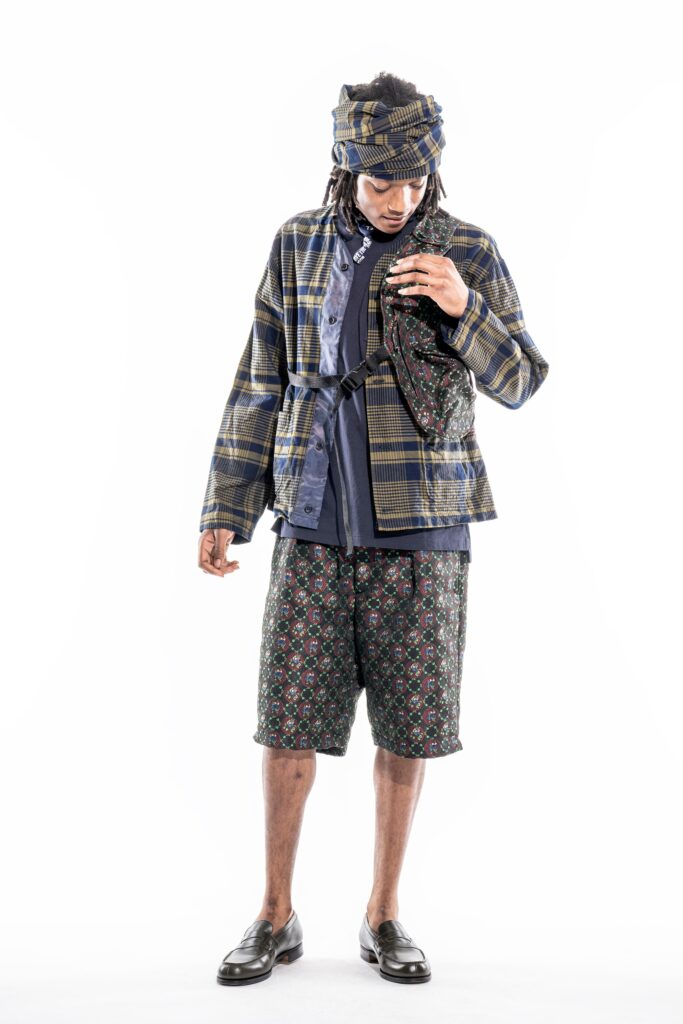 A relaxed-fit blue and green checked jacket paired with printed shorts.