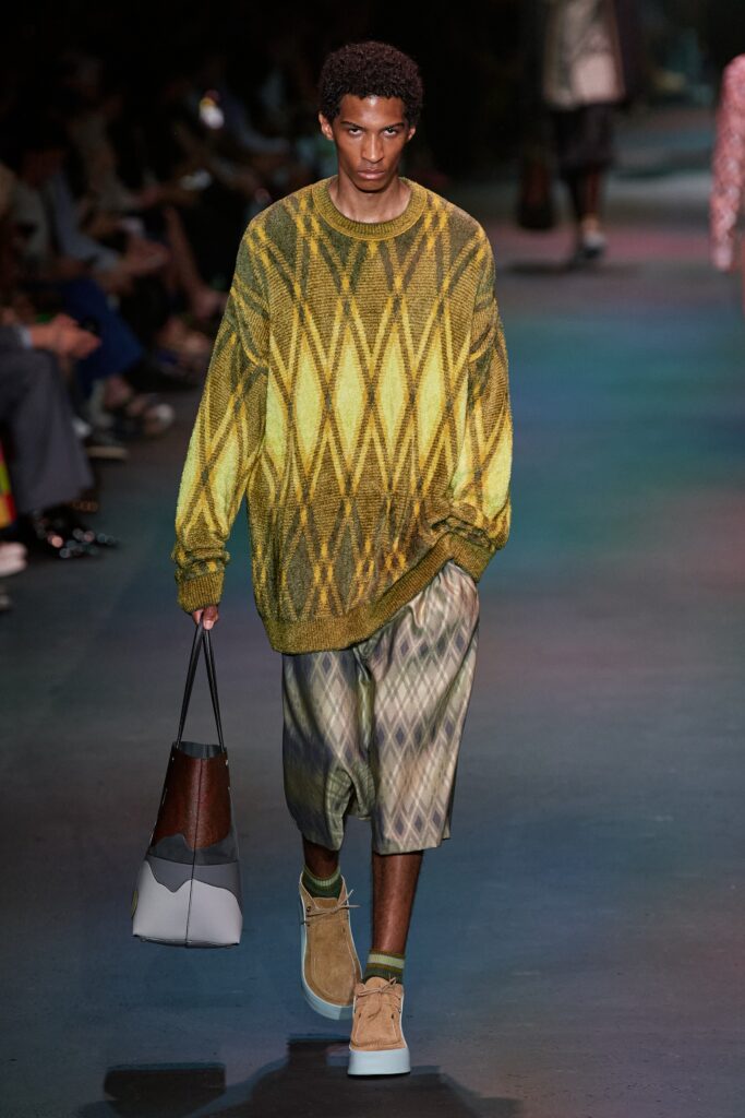 A relaxed yellow and green printed long-sleeve sweater paired with matching shorts.