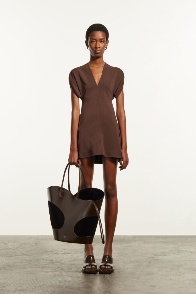 A fitted brown cotton dress with short sleeves and a V-neckline.