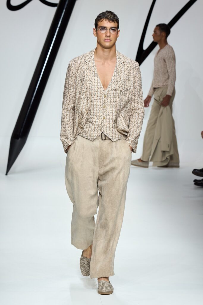 A relaxed beige cotton long-sleeve shirt with a V-neck and wide-leg pants.