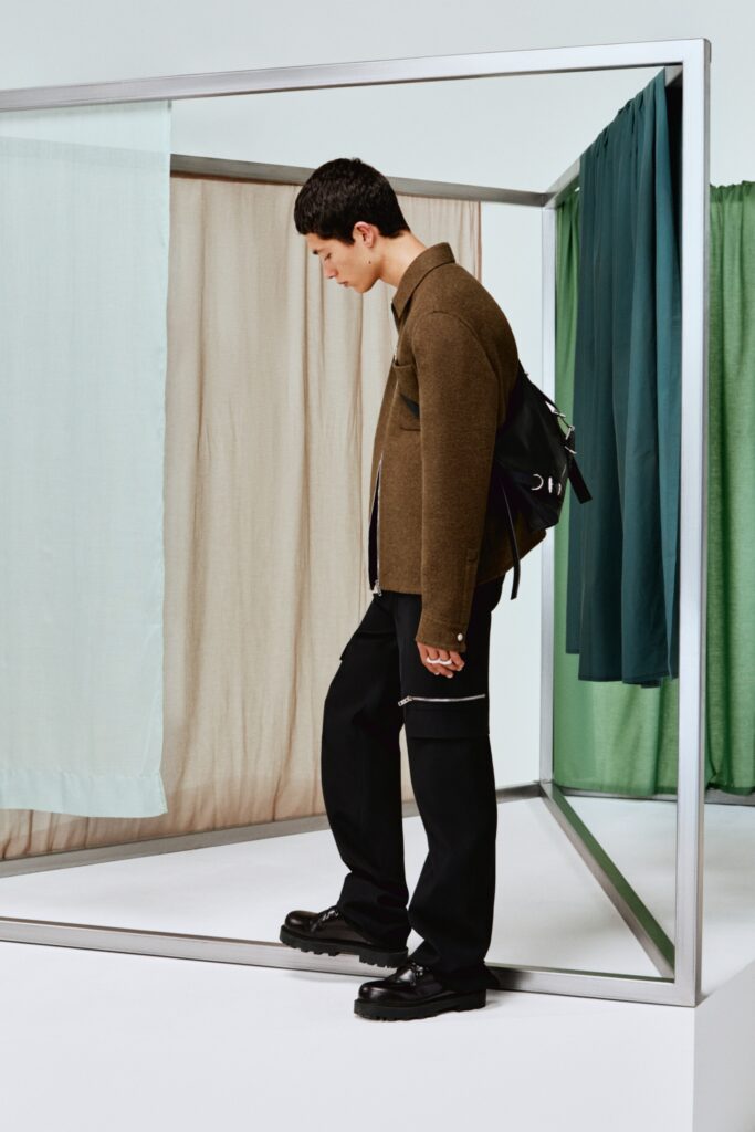 A relaxed brown cotton jacket paired with straight-leg black pants, perfect for a casual look.