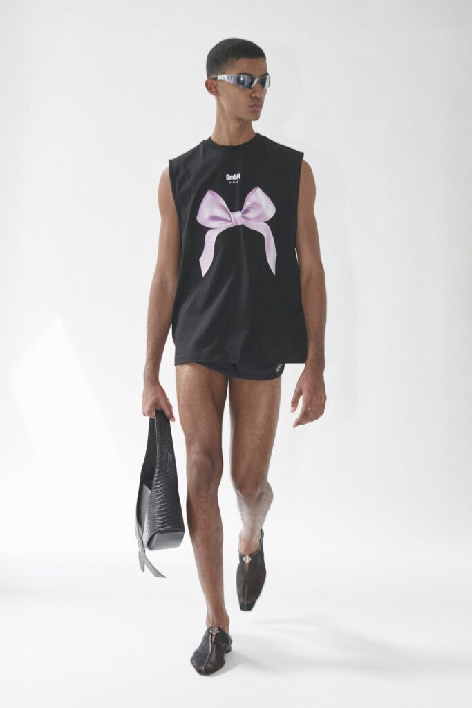 A relaxed black sleeveless top featuring a printed design, paired with matching shorts.
