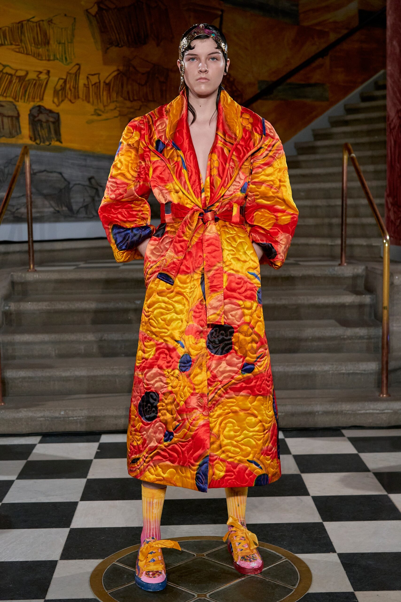 A relaxed fit long-sleeve coat in vibrant yellow, red, and black with a printed design.