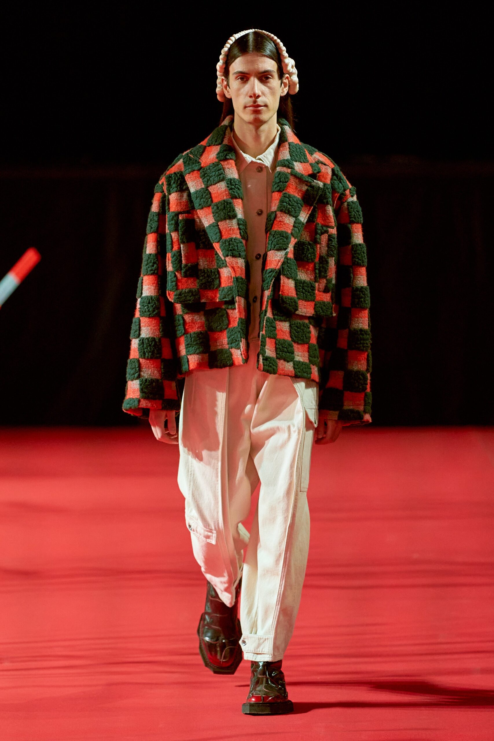 A relaxed-fit checked jacket paired with loose-fitting pants for a contemporary look.