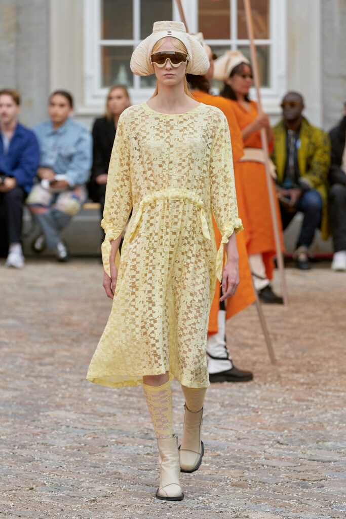 A relaxed yellow sheer long-sleeve dress with a tiered design detail.