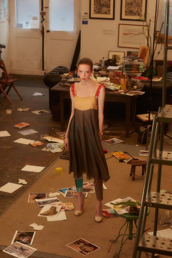 A relaxed brown and yellow sleeveless dress with a V-neckline and tiered design.