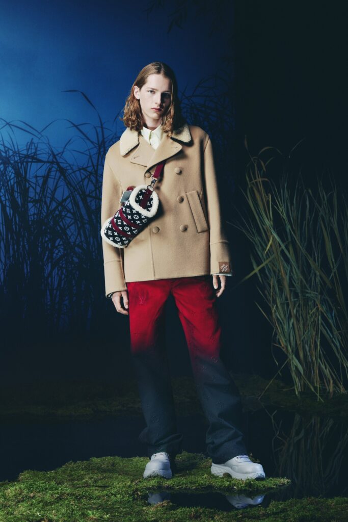 A relaxed-fit beige jacket with long sleeves paired with high-waisted red flared pants.