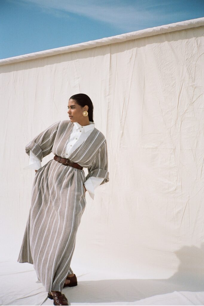 A relaxed long-sleeve striped dress with a collared neckline and belted waist.