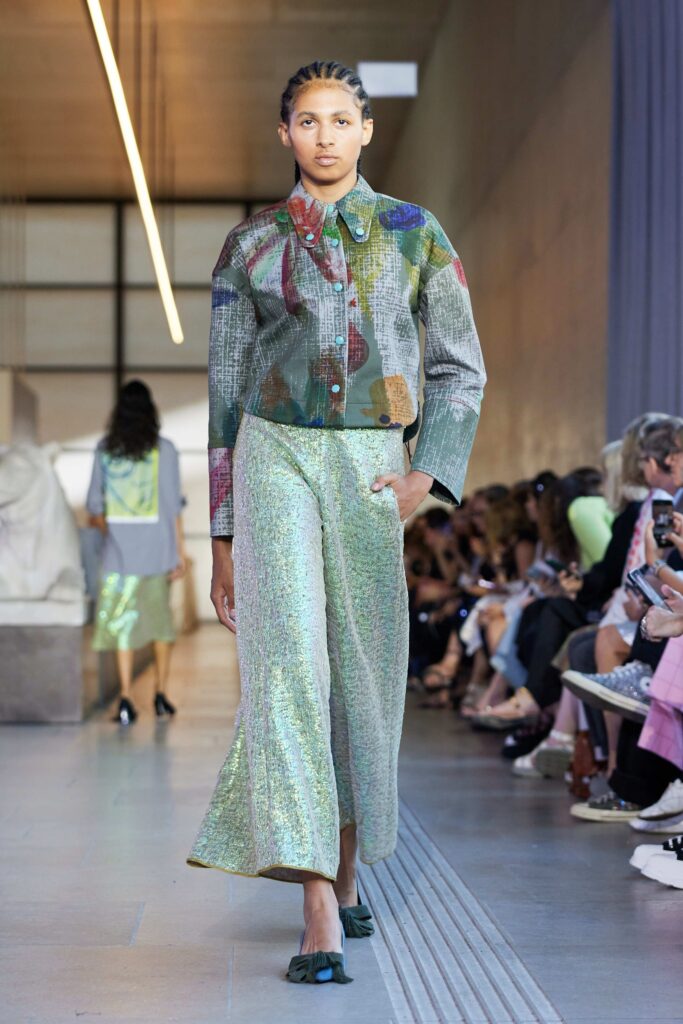 An oversized multicolor silk jacket paired with wide-leg green pants, perfect for a chic runway look.