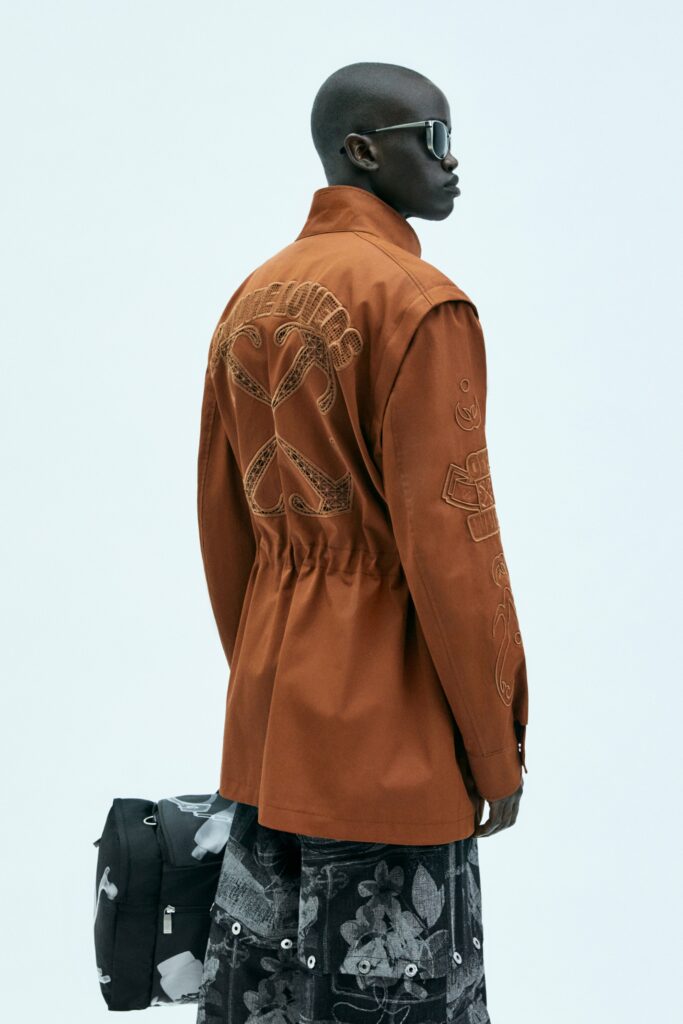 orange embroidered jacket and black flared skirt