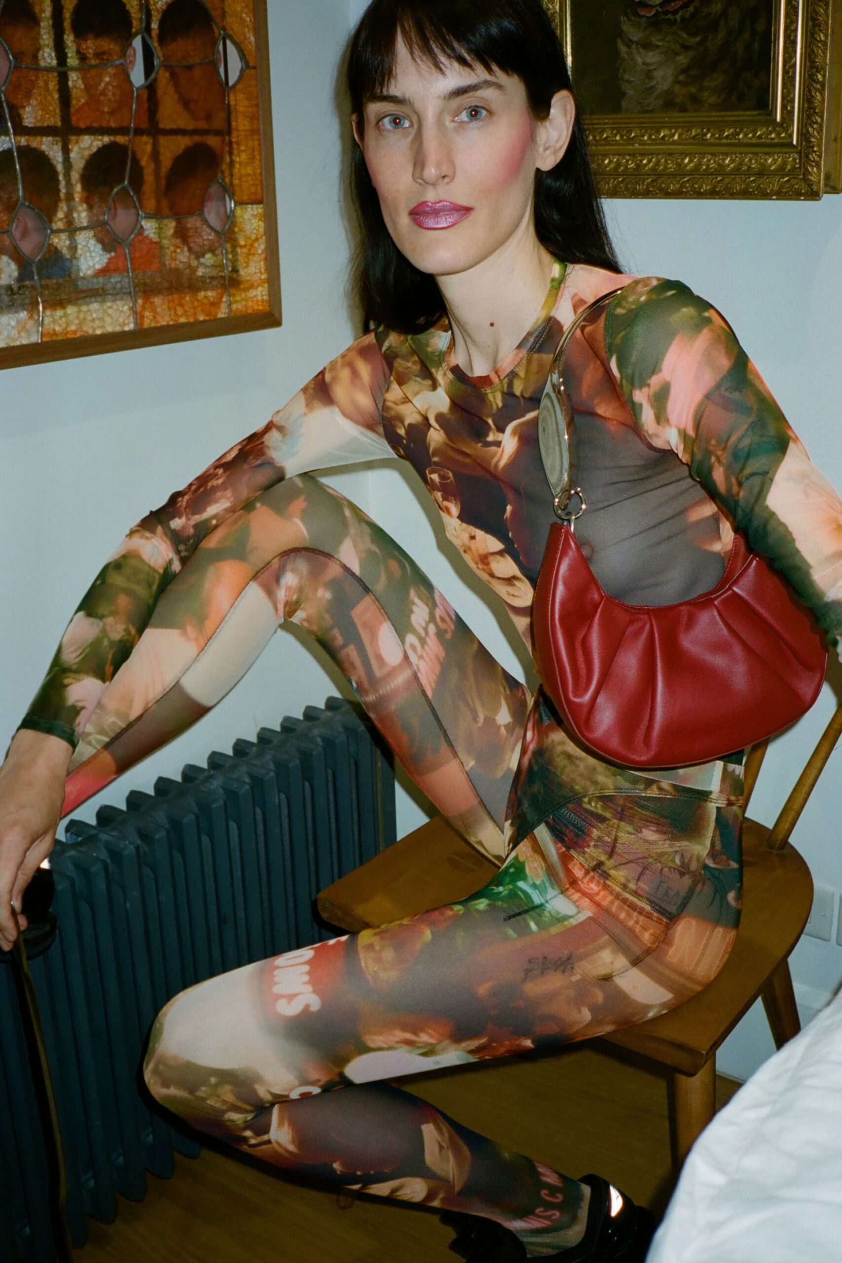 A fitted multicolor long-sleeve catsuit with a high neckline and printed design.