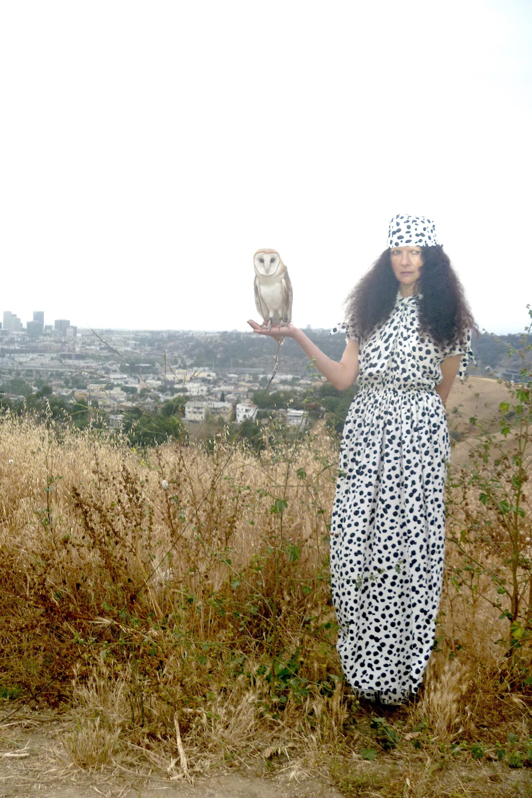 A relaxed white and black printed dress with a collared neckline and sleeveless design.