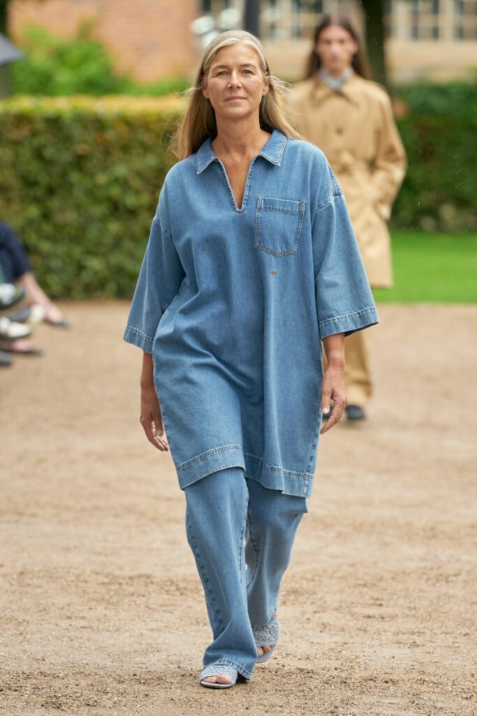 A relaxed blue denim dress with a V-neckline and short sleeves, paired with matching pants.