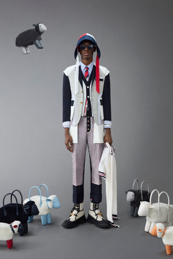 A fitted white jacket with a collared neckline paired with high-waisted navy striped pants.