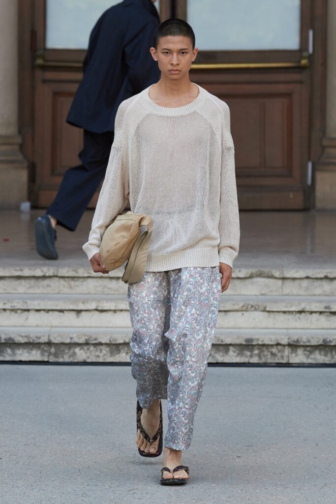 An oversized beige sweater paired with multicolor printed pants for a relaxed look.