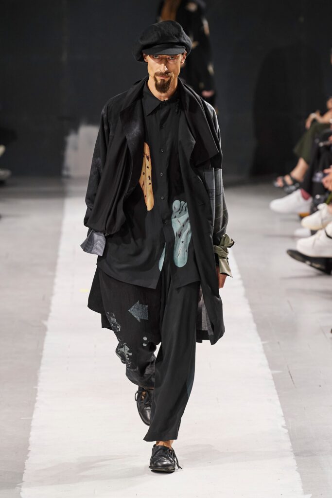A relaxed black jacket with long sleeves and a collared design, paired with matching pants.