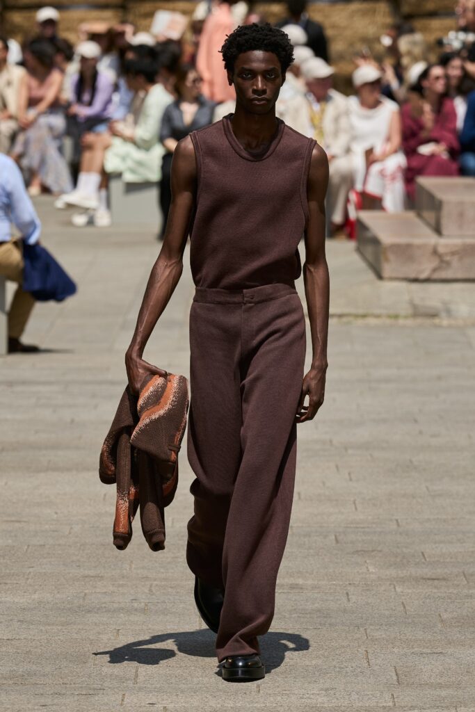 A relaxed brown sleeveless top paired with wide-leg pants for a modern look.
