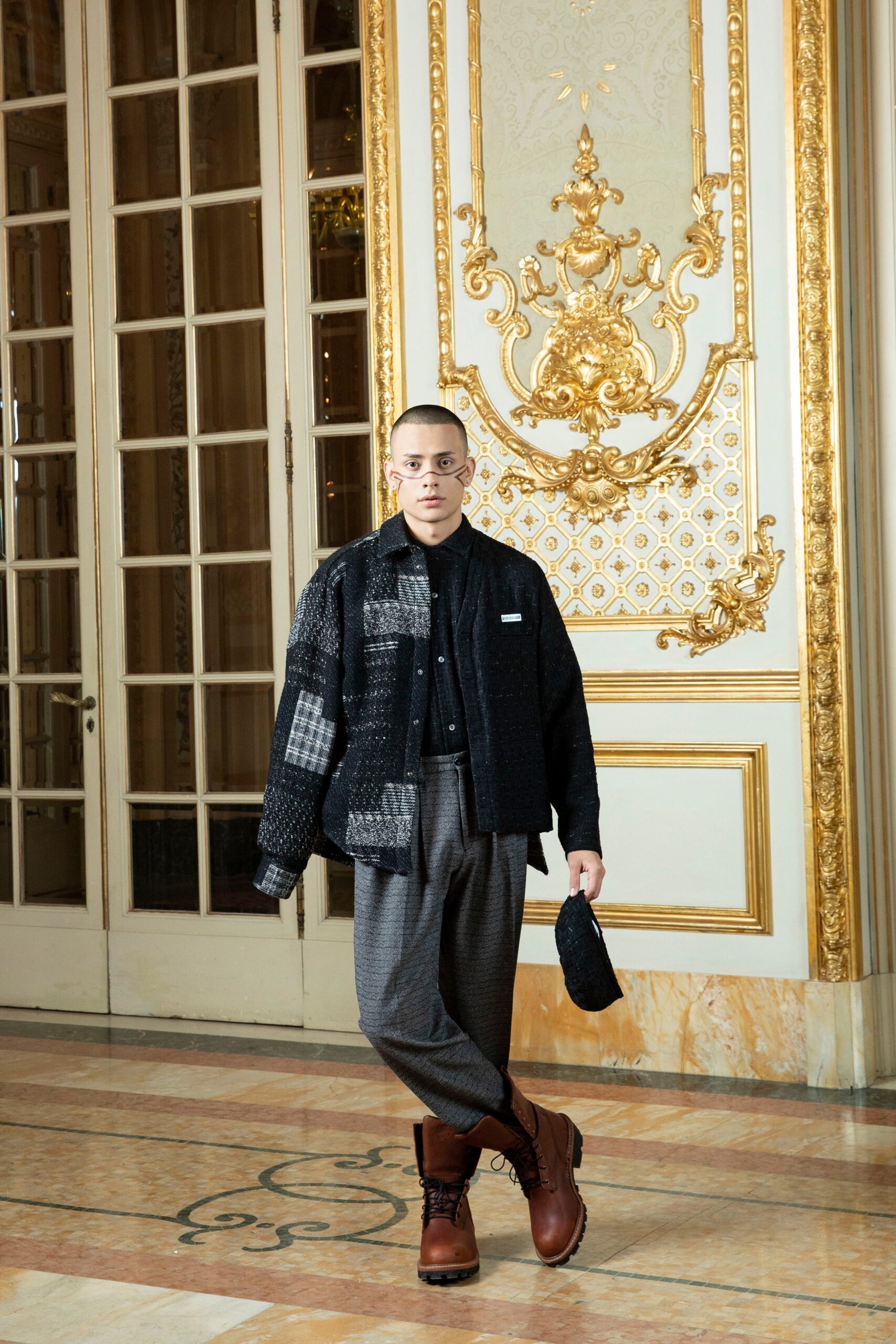 A relaxed black jacket with a collared neckline paired with gray checked pants.