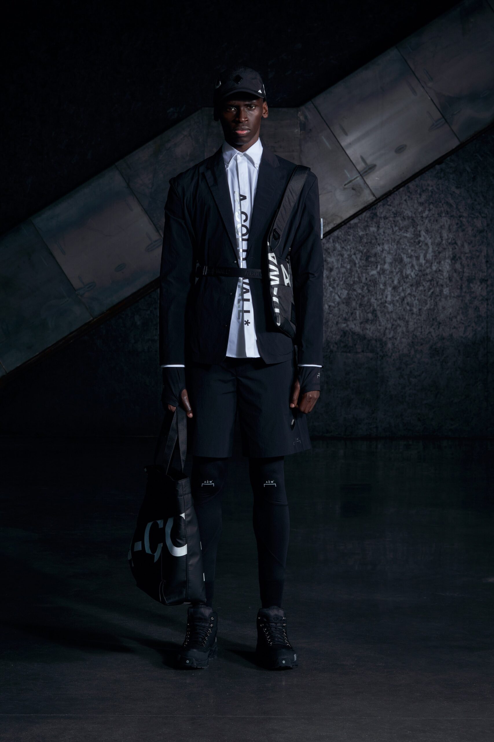 A relaxed black jacket with long sleeves and a collared neckline paired with matching shorts.
