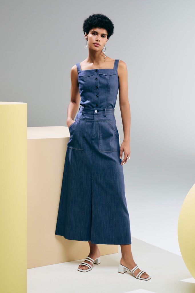 A fitted blue denim dress with a sleeveless design and A-line silhouette.