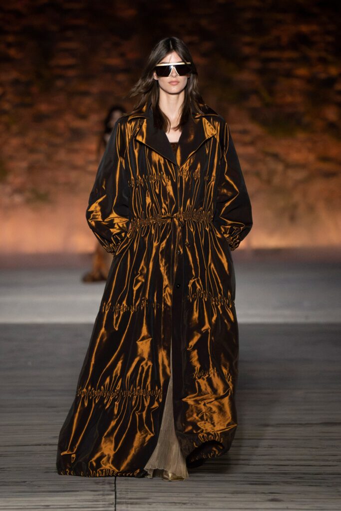 A relaxed black and brown silk coat with long sleeves and a collared design.