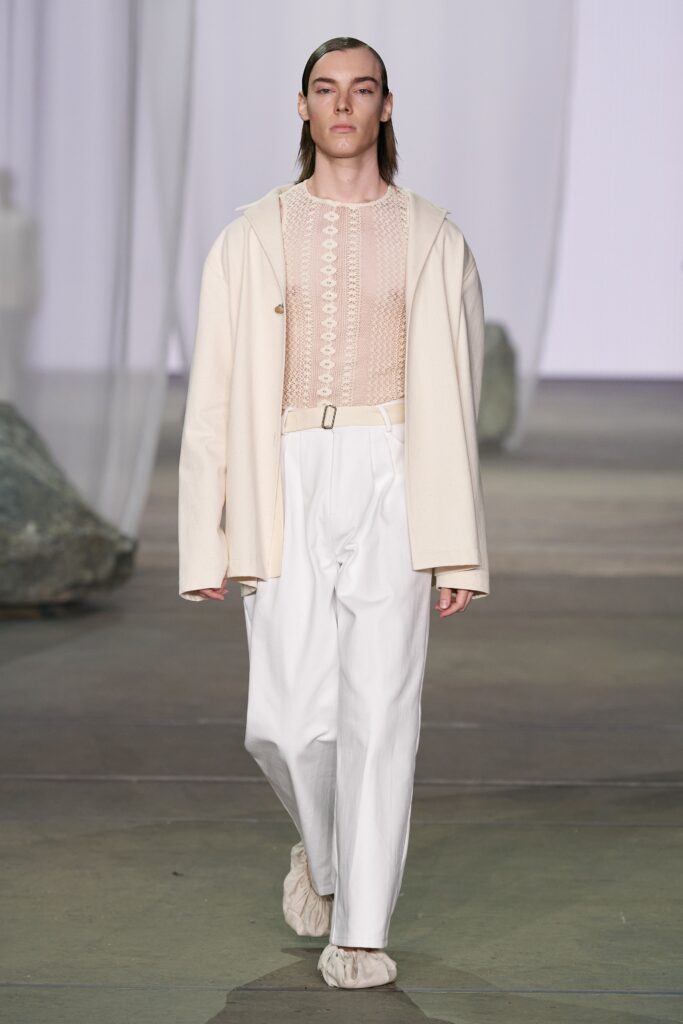 A relaxed white jacket with long sleeves and matching pants, featuring a buttoned design.