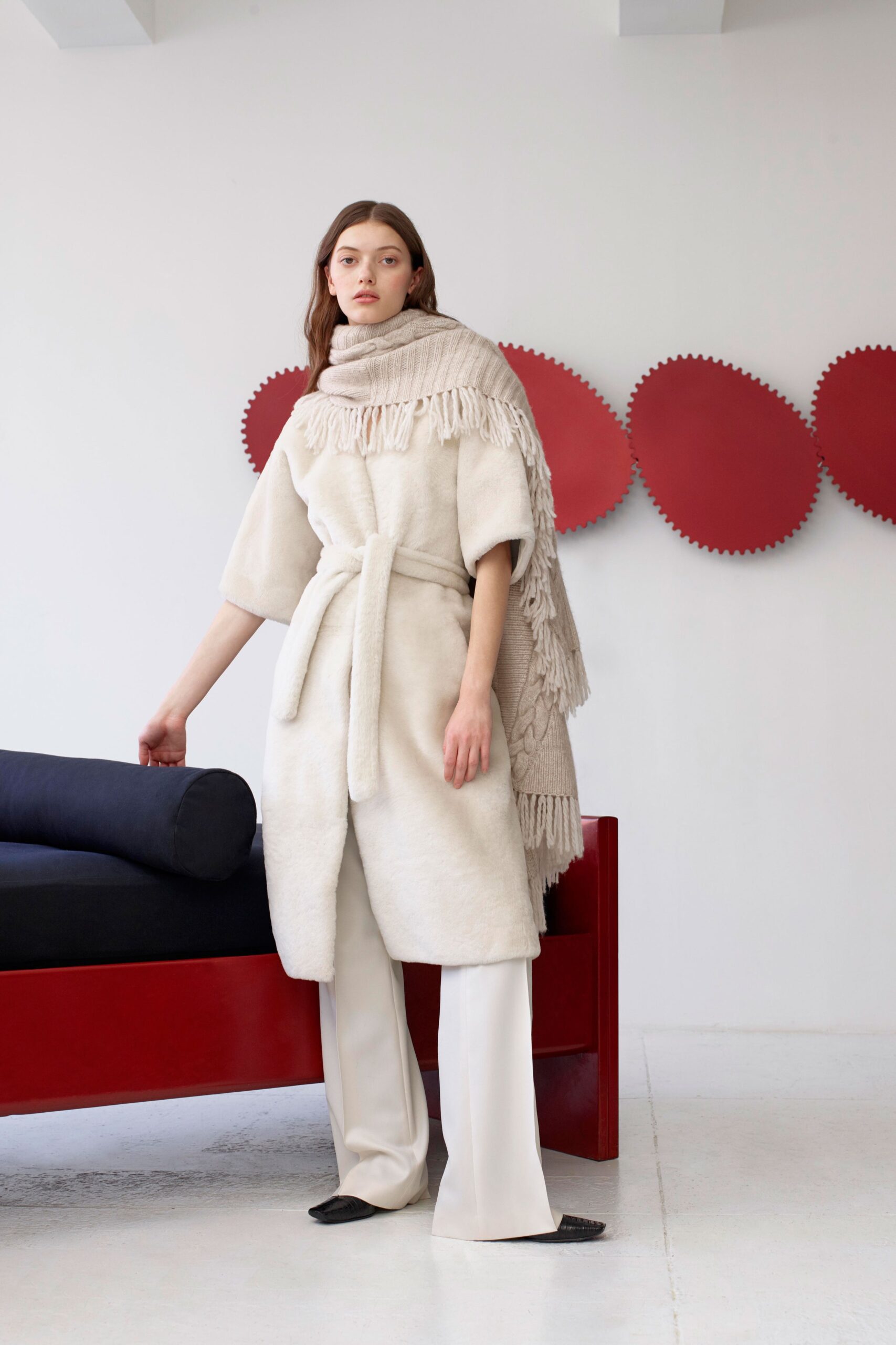 white faux-fur coat with beige pants