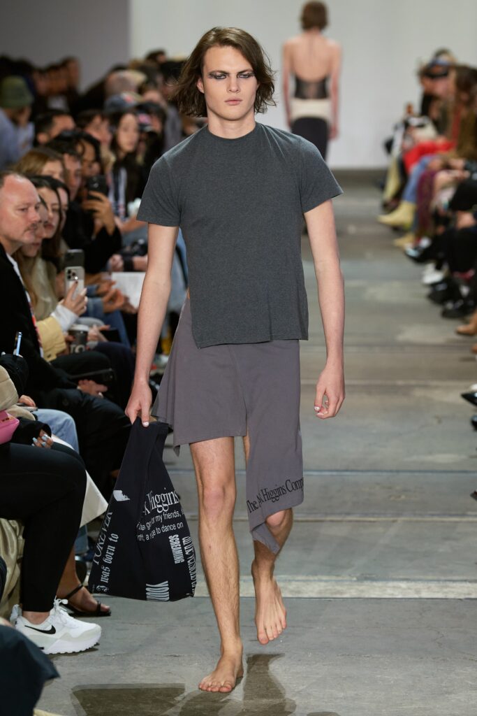 A relaxed gray t-shirt with short sleeves paired with asymmetric shorts.