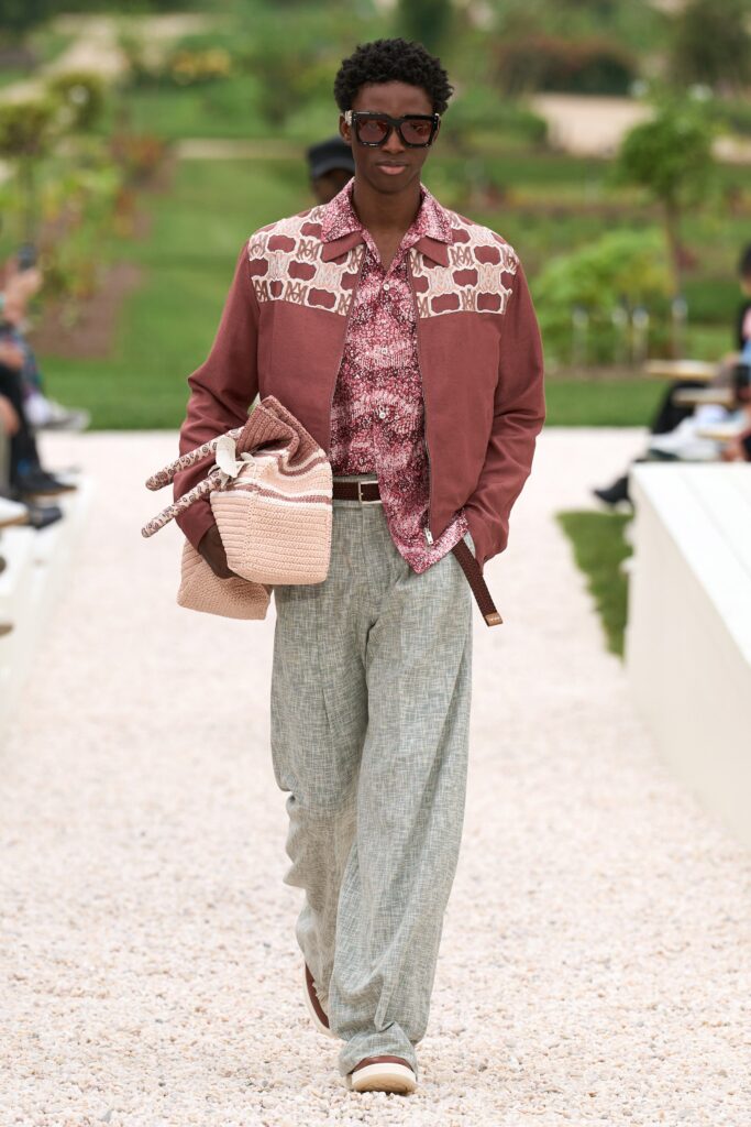 A relaxed brown printed jacket paired with wide-leg gray pants for a stylish look.