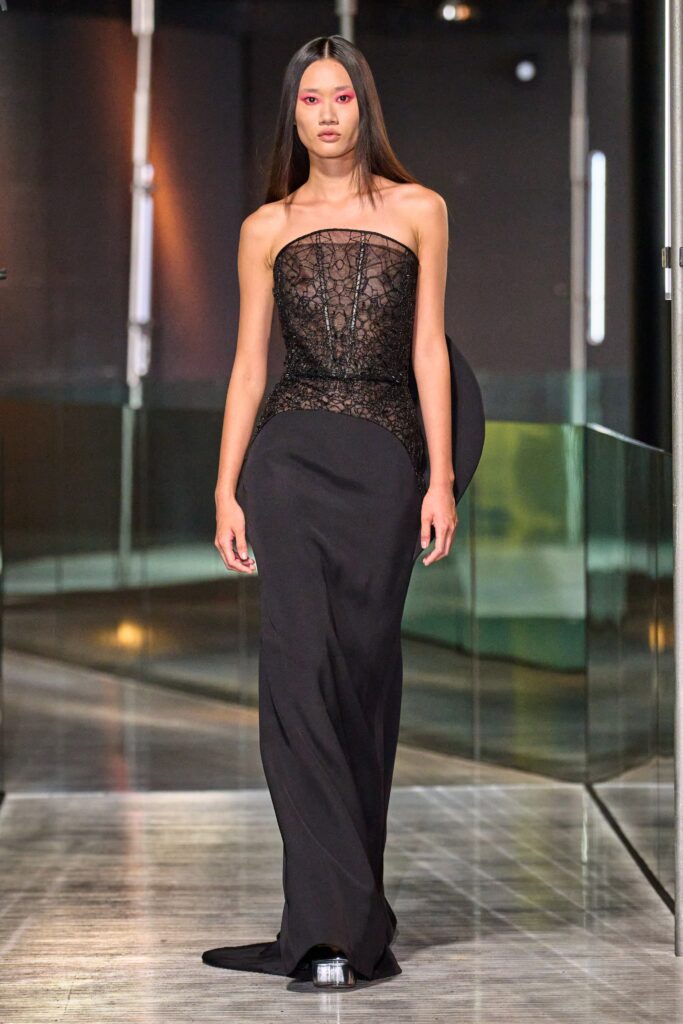 A fitted black lace strapless gown with a V-neckline and a stylish slit.