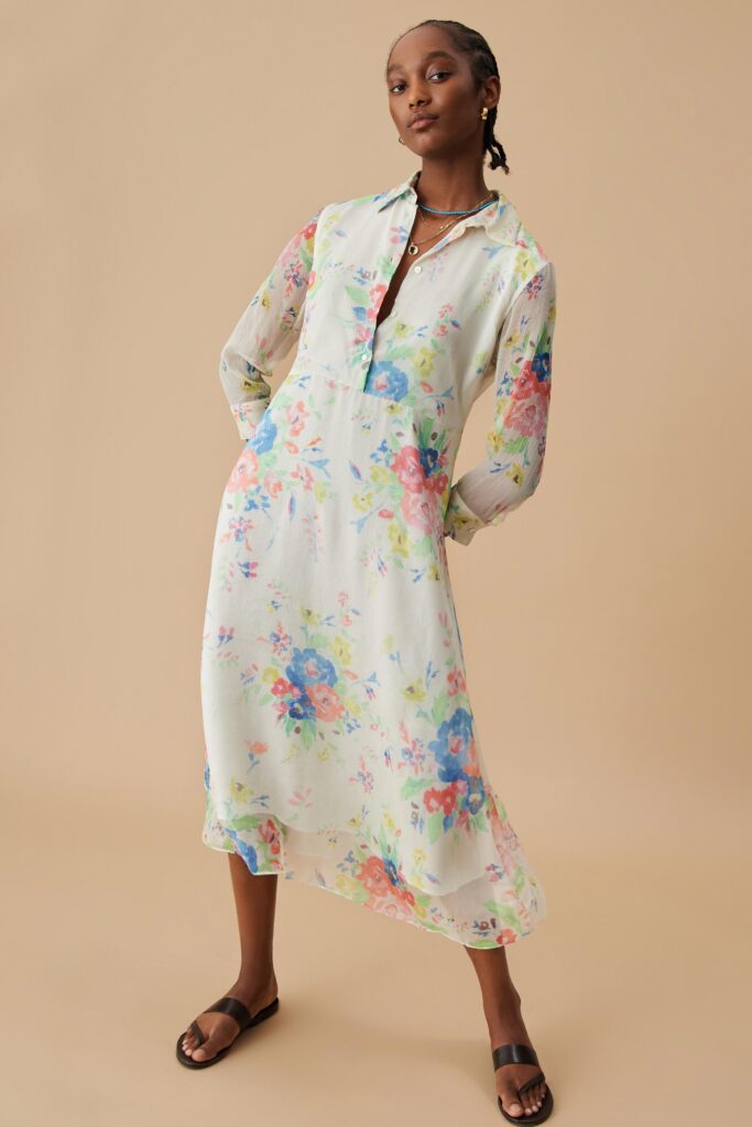 A relaxed multicolor floral dress with long sleeves and a collared neckline.