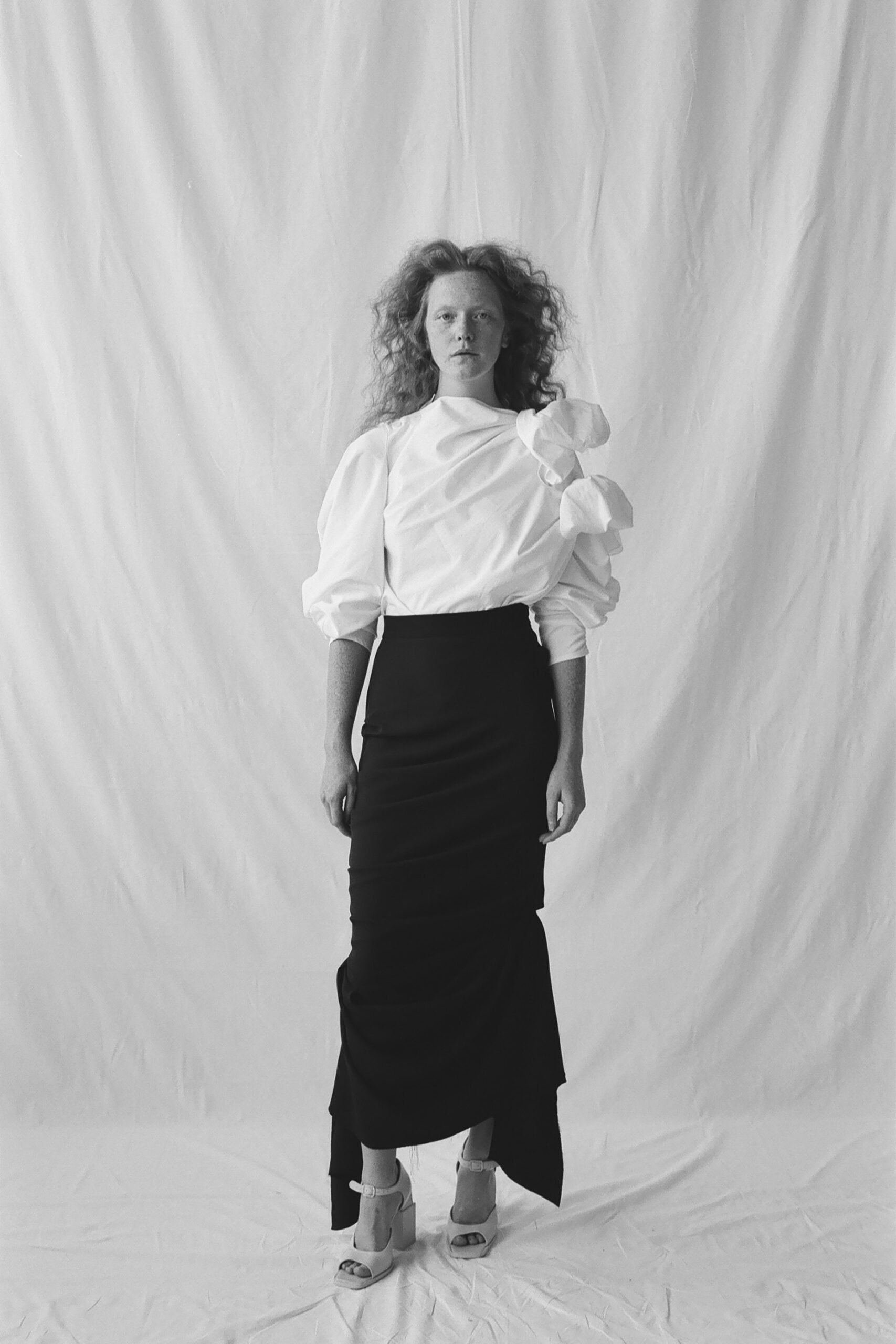 white cotton long-sleeve high-neck fitted ruffled blouse