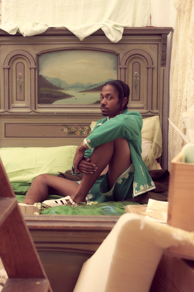 A relaxed green cotton sleeveless dress with a V-neckline and embroidered details.