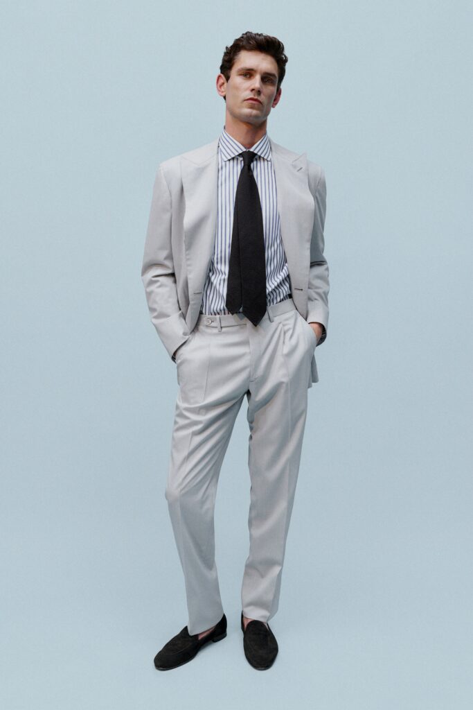 A tailored gray suit with a collared long-sleeve shirt featuring stripes.