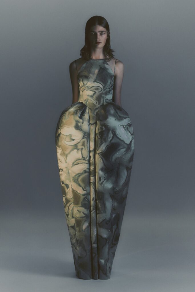 A fitted multicolor silk sleeveless dress with a high-neck and asymmetric design.