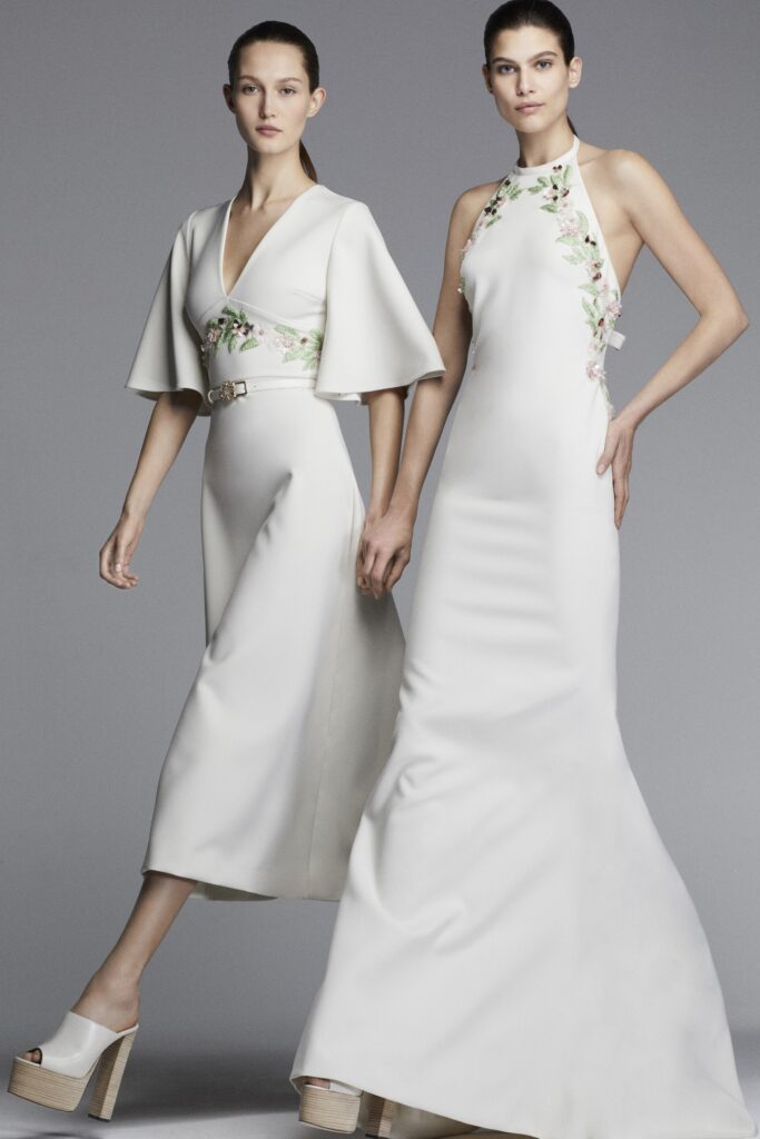 A fitted white silk dress with a V-neckline and flared silhouette.