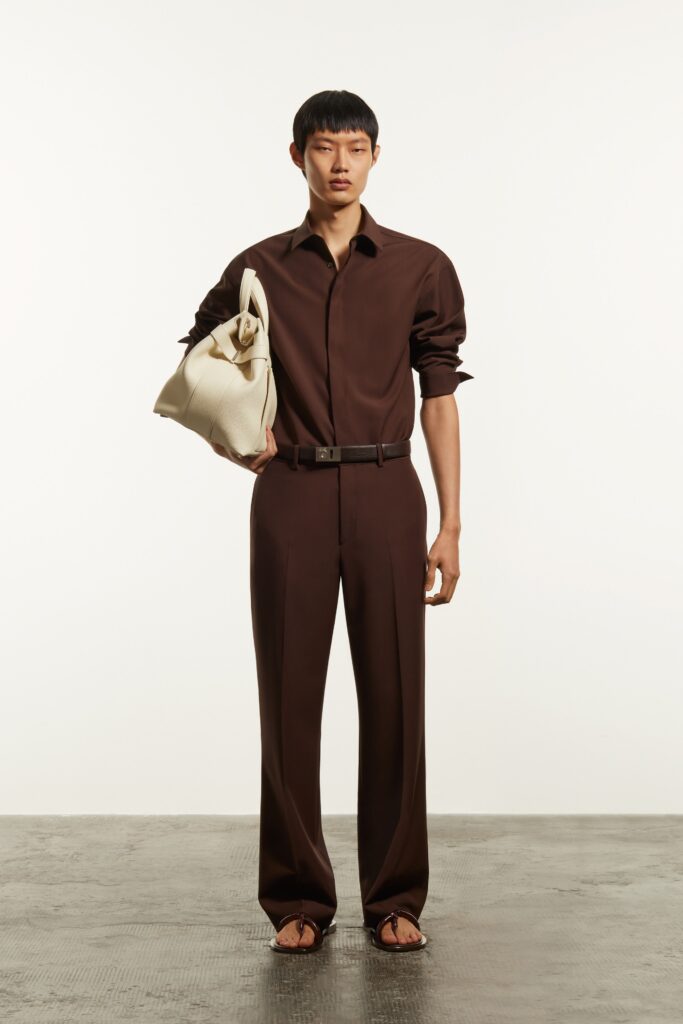 A relaxed brown cotton long-sleeve shirt paired with straight-leg pants.