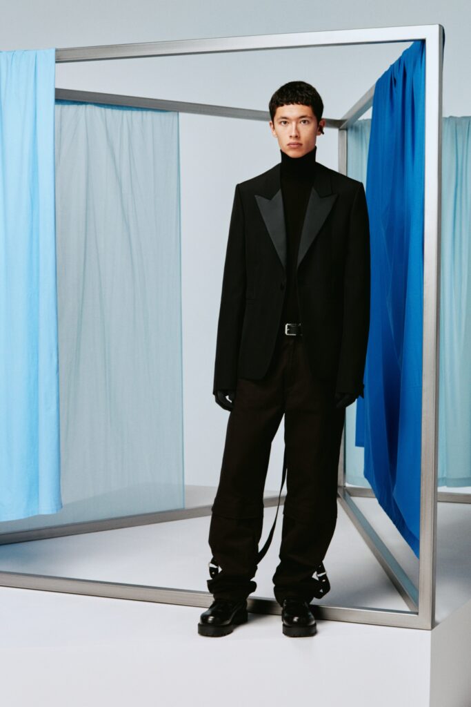 A fitted black wool blazer with long sleeves and structured pants for a sleek look.