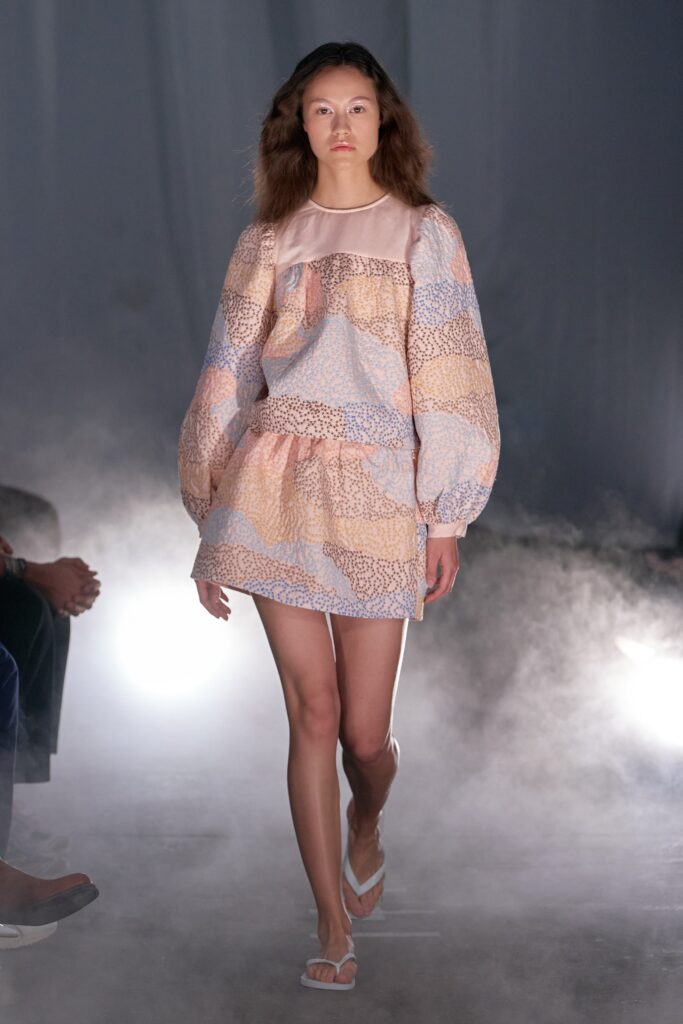 A relaxed multicolor dress with long sleeves and a tiered design.
