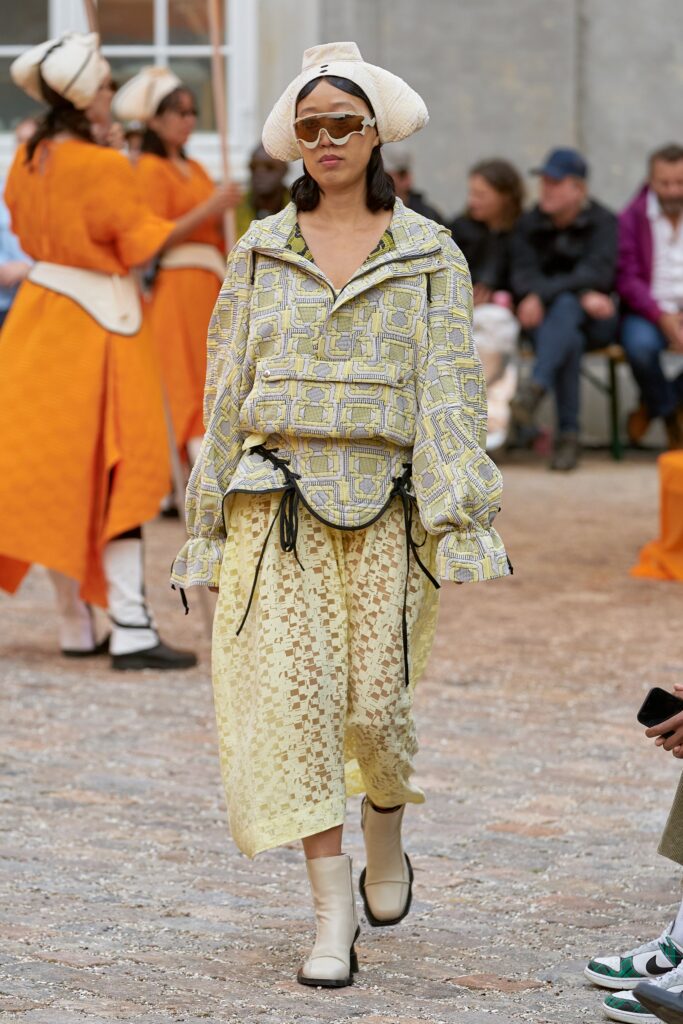 A relaxed yellow and cream printed top with a collared long-sleeve and layered skirt.