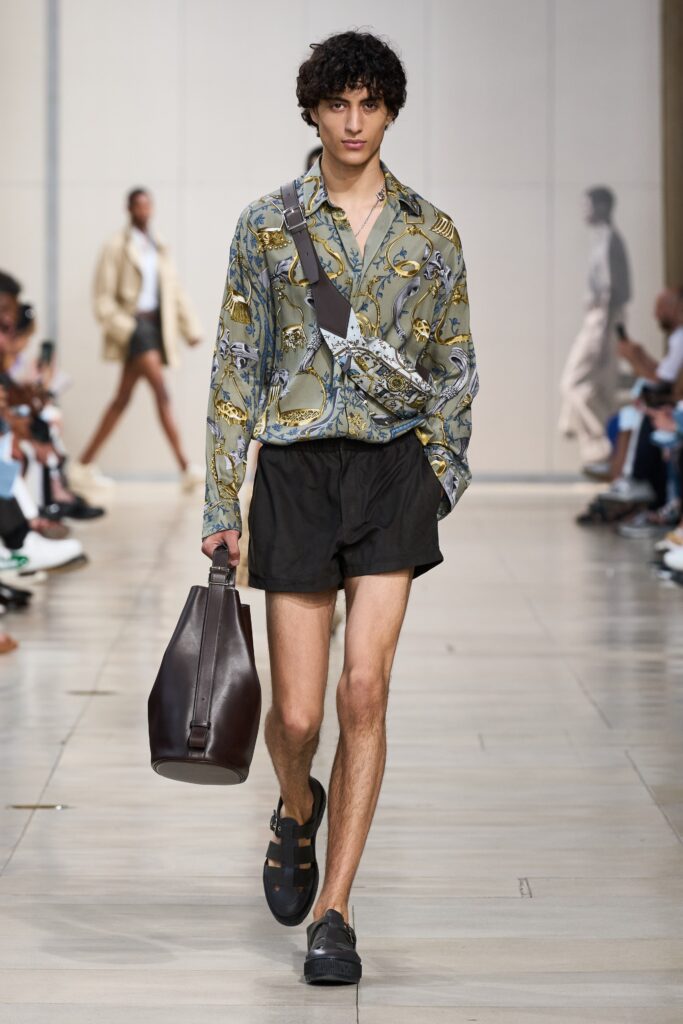 A relaxed-fit green printed shirt with long sleeves paired with black shorts.