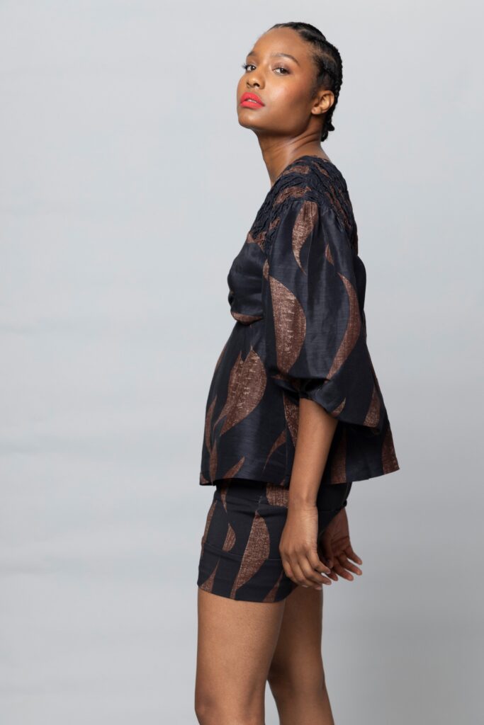 A relaxed black and brown printed top paired with matching shorts for a chic look.