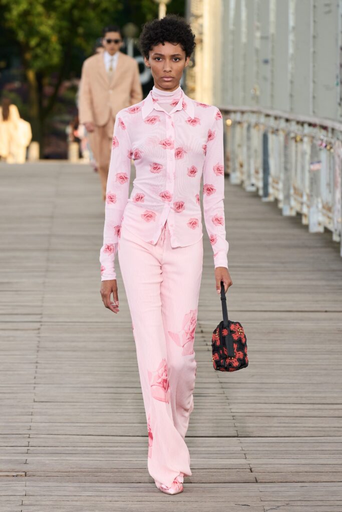 A fitted pink floral long-sleeve shirt paired with wide-leg pants.