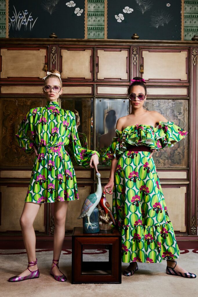 A relaxed green cotton off-shoulder dress with a flared and tiered design.