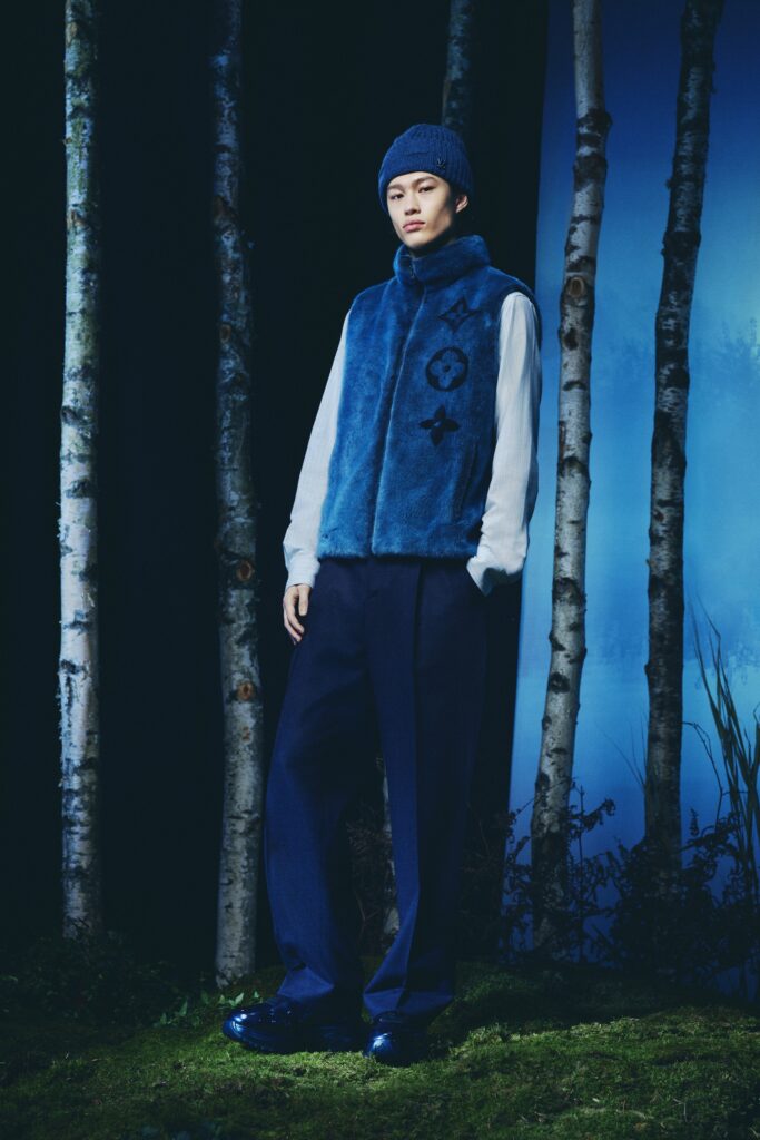 A relaxed blue faux-fur sleeveless vest with collared detail paired with relaxed-fit pants.