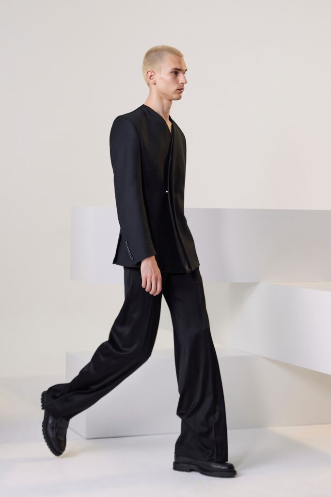 A tailored black blazer with long sleeves and straight-leg pants for a sophisticated look.